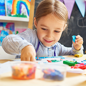 Child painting at table