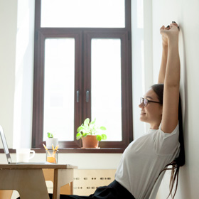 woman sitting in chair stretching