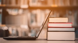 Image of a computer and books