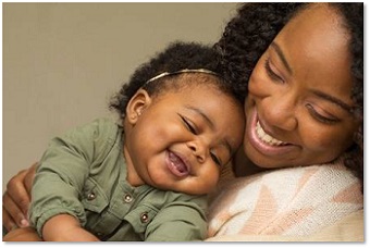 Baby and mother smiling