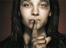 Victim of domestic abuse covering her mouth