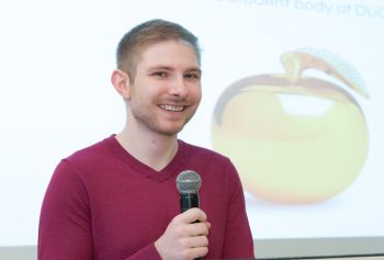 A student announcing the Golden Apple Award recipient