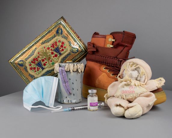 still-life photo with decorative box, shoe, jar, mask, vial and doll