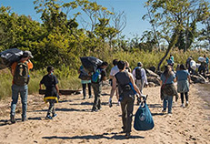 volunteers cleaning up a beach