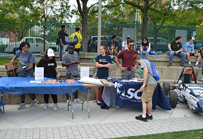Students behind a table promoting organizations