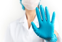 Physician holding their gloved hand