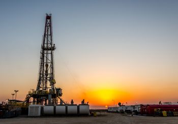 A fracking rig at sunset